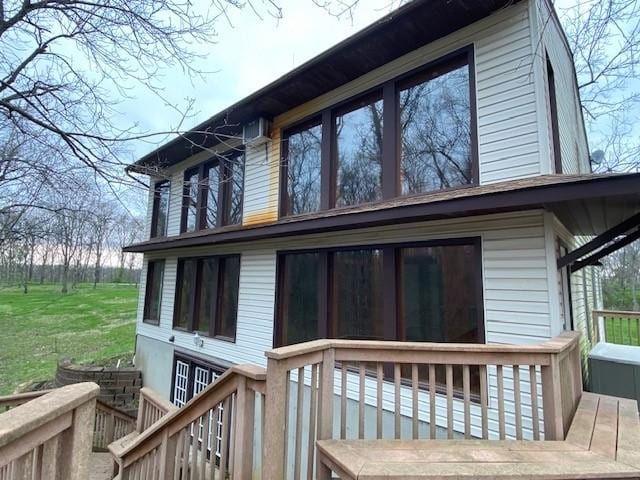 rear view of property featuring a deck
