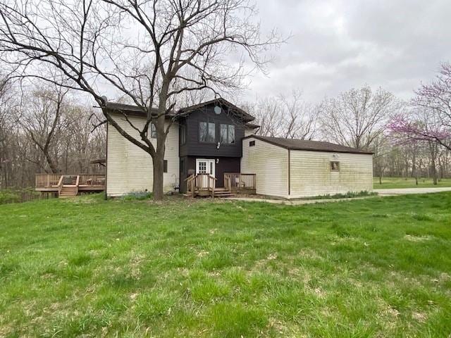 back of house with a lawn and a wooden deck