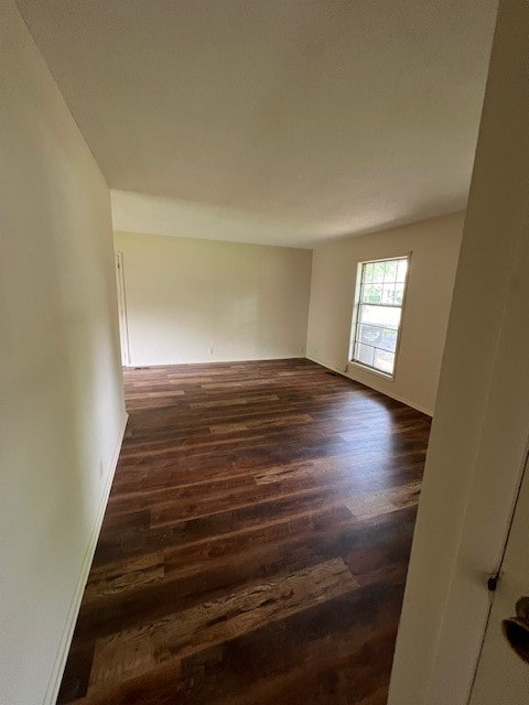 spare room featuring dark hardwood / wood-style floors