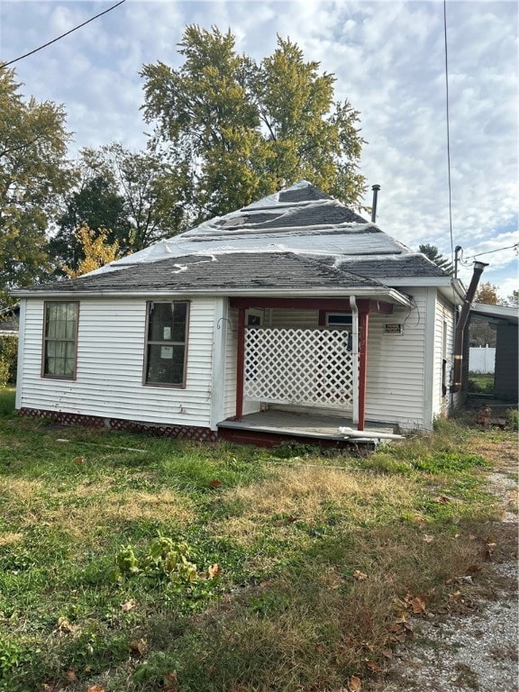 rear view of property with a yard