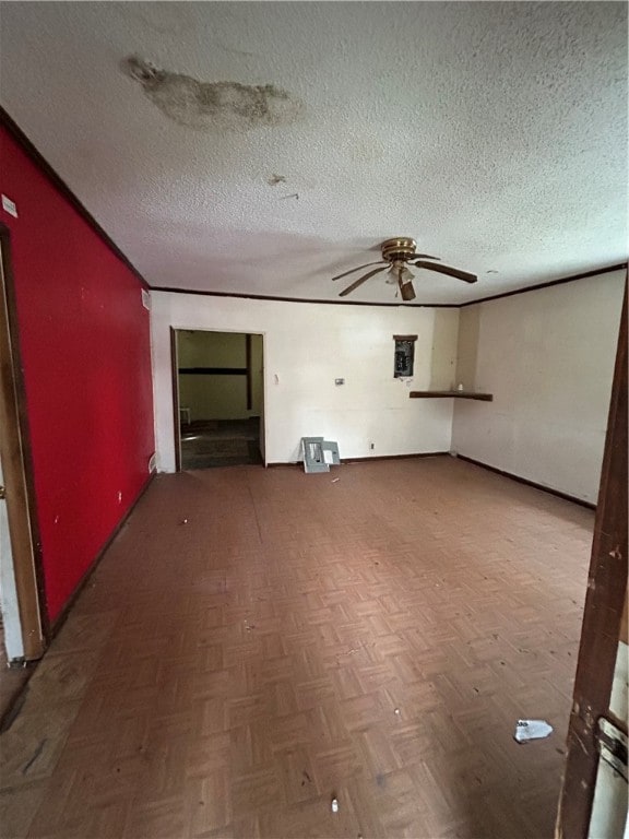 unfurnished living room with dark parquet flooring and a textured ceiling