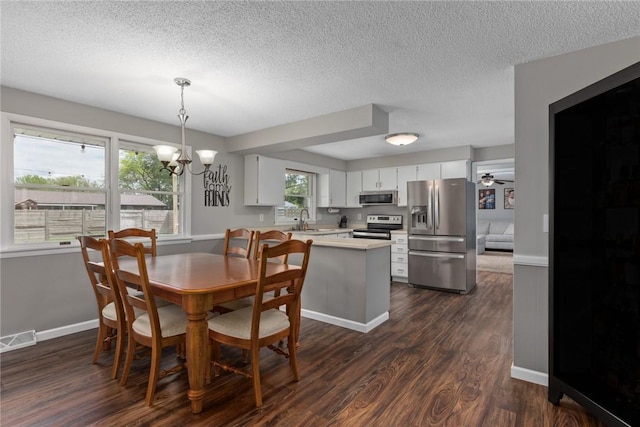 1108 Collins Dr, Effingham, IL 62401 - dining area featuring a chandelier, a textured ceiling, dark wood-style flooring, baseboards, and a ceiling fan