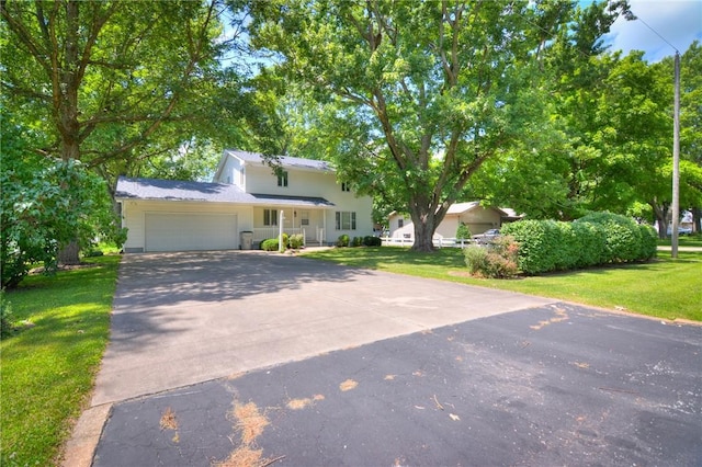 325 S Durfee St, Warrensburg, IL 62573 - view of front of home with asphalt driveway, a garage, and a front yard