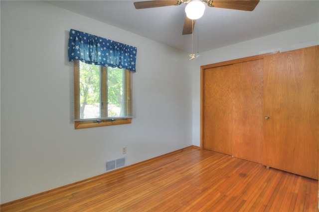 325 S Durfee St, Warrensburg, IL 62573 - unfurnished bedroom featuring wood-type flooring, a closet, and a ceiling fan