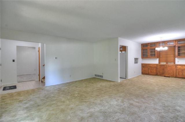 325 S Durfee St, Warrensburg, IL 62573 - unfurnished living room with a chandelier and light carpet