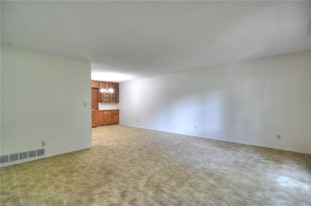 325 S Durfee St, Warrensburg, IL 62573 - unfurnished living room with a chandelier and light colored carpet