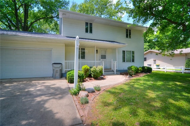 325 S Durfee St, Warrensburg, IL 62573 - view of front of home featuring a garage, covered porch, and concrete driveway