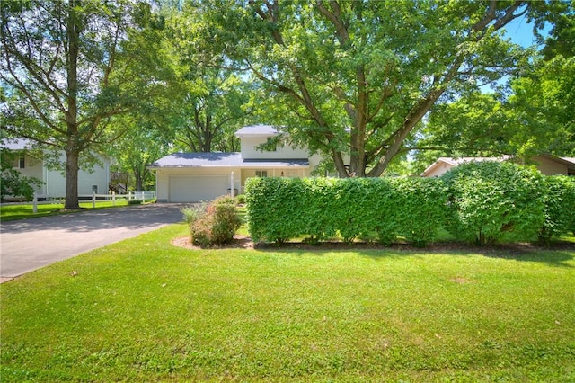 325 S Durfee St, Warrensburg, IL 62573 - view of front of property featuring asphalt driveway, a front lawn, and a garage