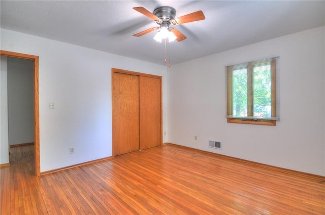 325 S Durfee St, Warrensburg, IL 62573 - unfurnished bedroom with wood finished floors, a closet, and a ceiling fan