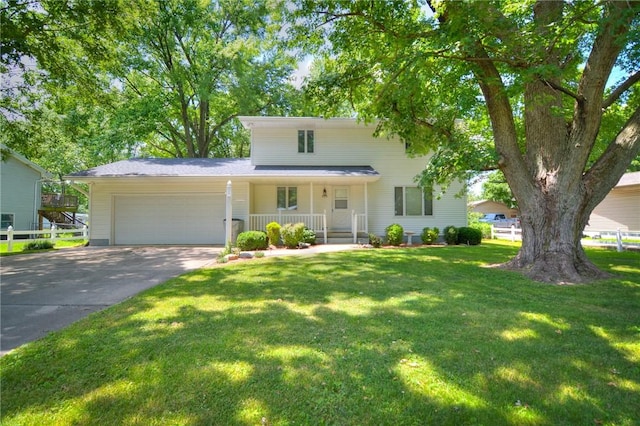 325 S Durfee St, Warrensburg, IL 62573 - view of front of house featuring an attached garage, a porch, concrete driveway, and a front lawn