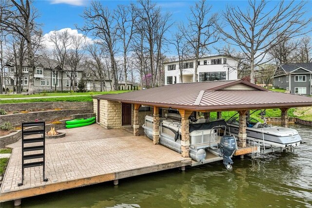 9219 E Best Ct, Effingham, IL 62401 - dock area featuring an outdoor fire pit, boat lift, a residential view, and a water view