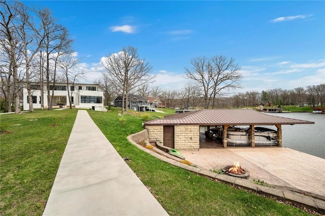 9219 E Best Ct, Effingham, IL 62401 - view of home's community with a carport, a lawn, an outdoor fire pit, driveway, and a dock