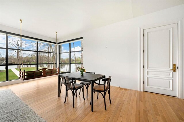 9219 E Best Ct, Effingham, IL 62401 - dining space with light wood-style flooring and a water view