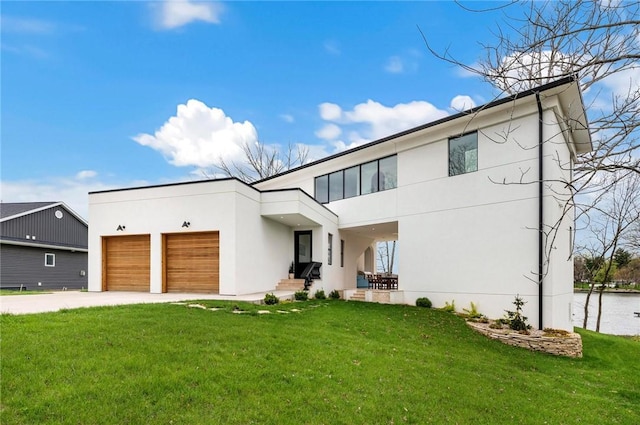 9219 E Best Ct, Effingham, IL 62401 - contemporary house with stucco siding, driveway, a front yard, and a garage