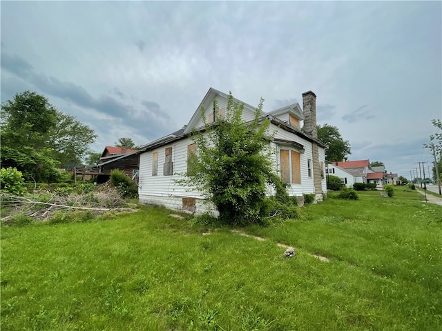 view of side of property with a yard