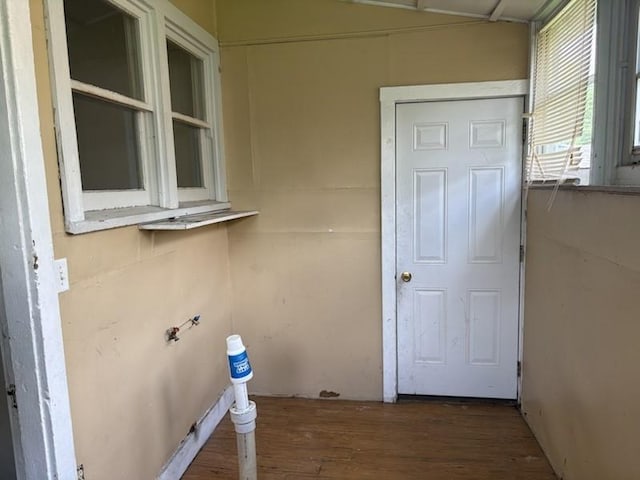laundry area with wood finished floors