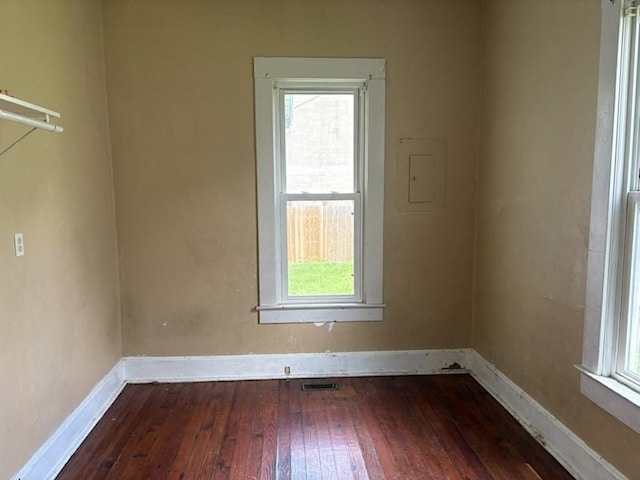 spare room with hardwood / wood-style floors and baseboards