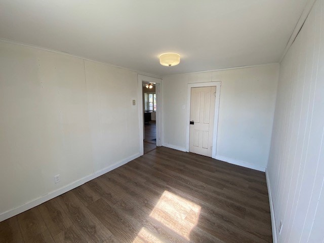 unfurnished room featuring dark hardwood / wood-style flooring