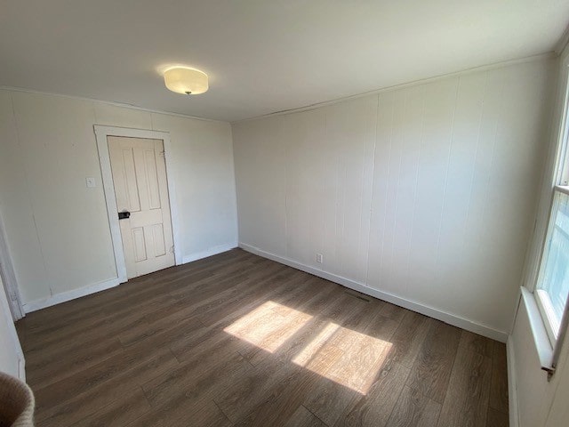 unfurnished room featuring dark hardwood / wood-style floors