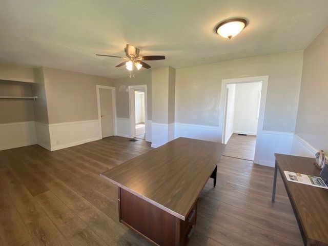 interior space featuring ceiling fan and dark wood-type flooring