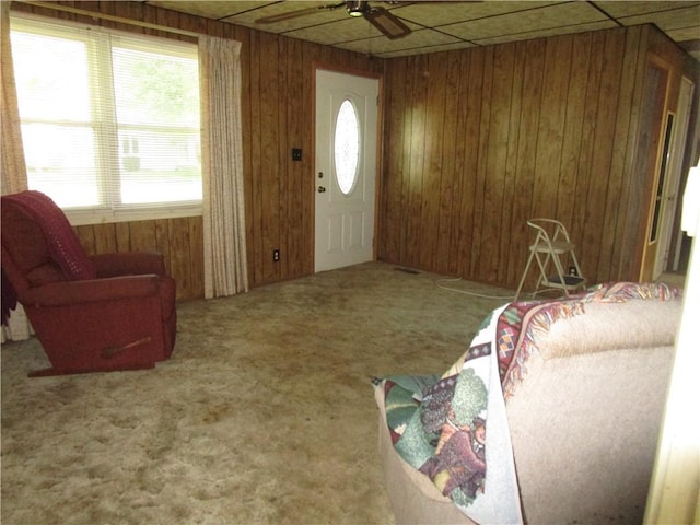 136 Macarthur Blvd, Pana, IL 62557 - foyer entrance featuring carpet flooring, healthy amount of natural light, wooden walls, and a ceiling fan