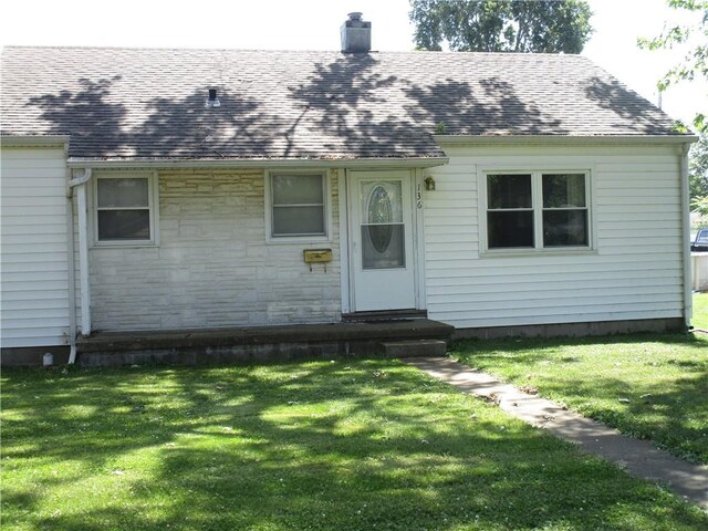 136 Macarthur Blvd, Pana, IL 62557 - view of front of property featuring entry steps, a chimney, a shingled roof, and a front lawn
