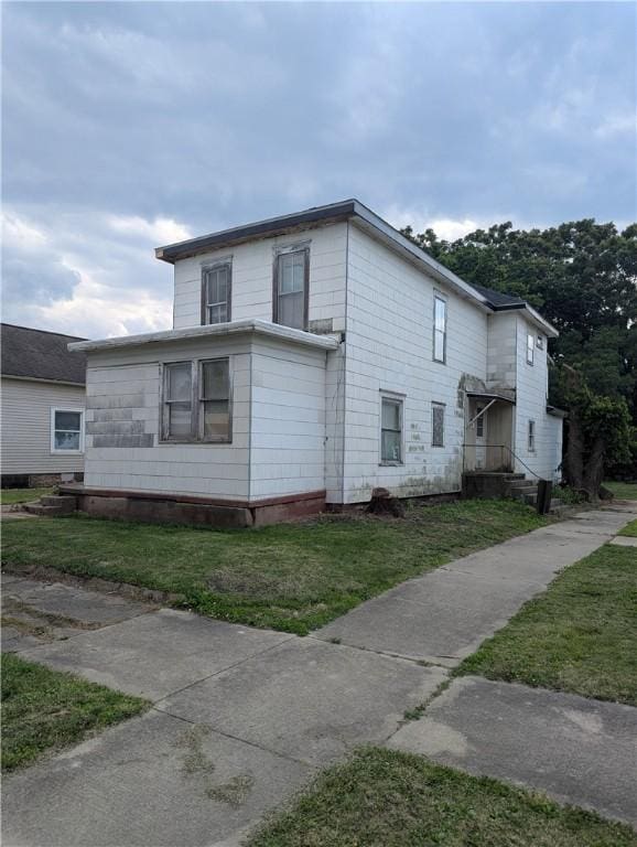 321 N 16th St, Mattoon, IL 61938 - view of home's exterior featuring a yard