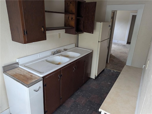 321 N 16th St, Mattoon, IL 61938 - kitchen featuring open shelves, a sink, light countertops, dark flooring, and dark brown cabinetry