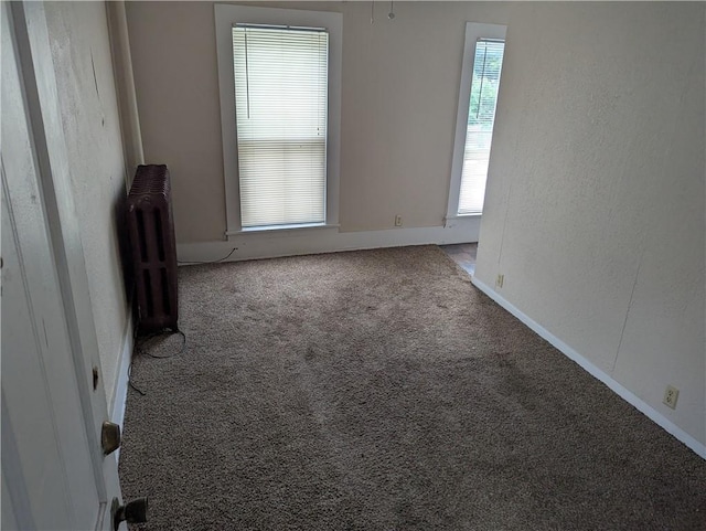 321 N 16th St, Mattoon, IL 61938 - carpeted empty room with radiator and baseboards