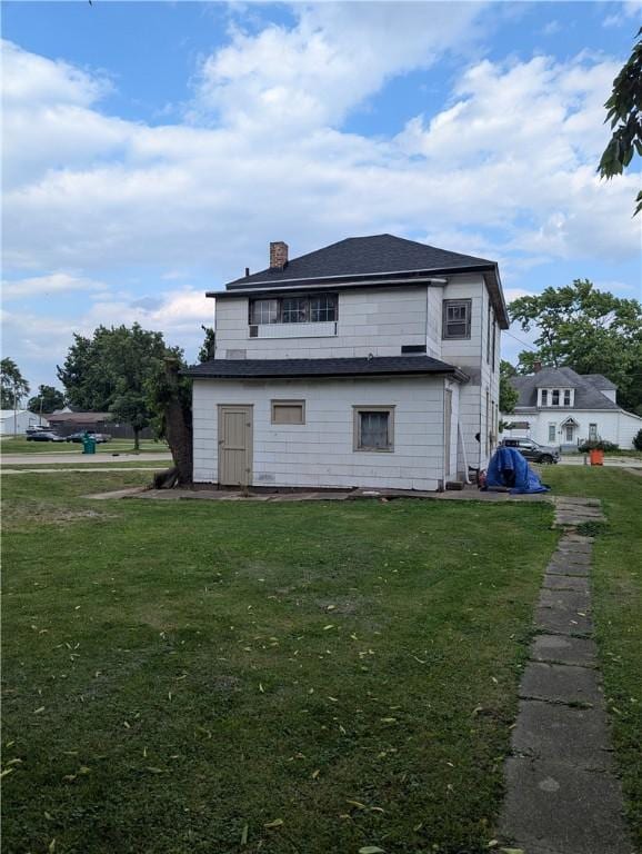 321 N 16th St, Mattoon, IL 61938 - back of house featuring a lawn and a chimney