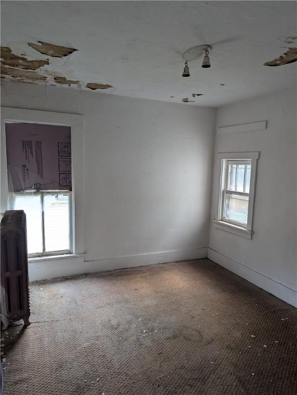 321 N 16th St, Mattoon, IL 61938 - carpeted empty room with radiator