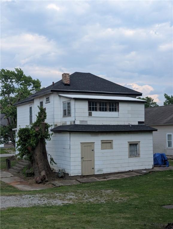 321 N 16th St, Mattoon, IL 61938 - back of property featuring a lawn, a chimney, and roof with shingles
