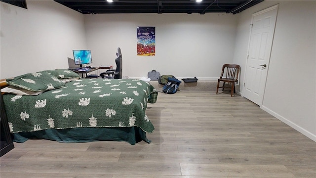 bedroom featuring baseboards and wood finished floors
