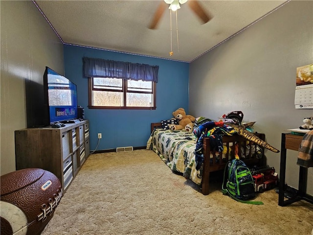 bedroom featuring visible vents, baseboards, carpet, and a ceiling fan