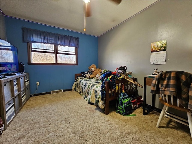carpeted bedroom featuring visible vents, baseboards, and a ceiling fan