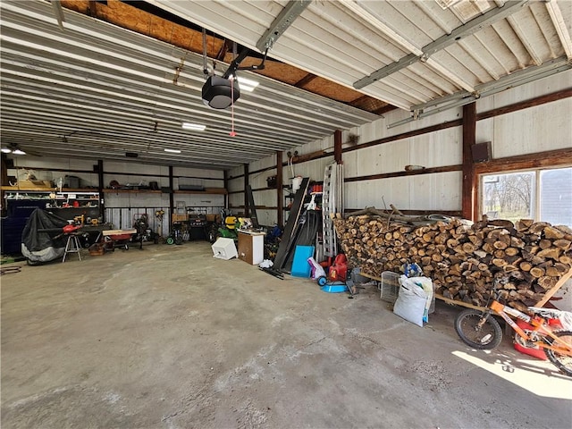garage featuring metal wall and a garage door opener