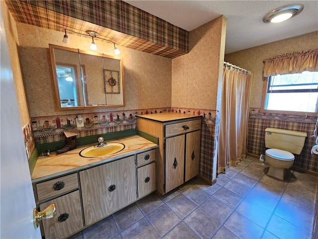 bathroom featuring tile patterned flooring, toilet, wallpapered walls, and vanity