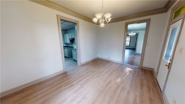 1204 N Franklin St, Danville, IL 61832 - empty room featuring a chandelier, ornamental molding, light wood finished floors, and baseboards