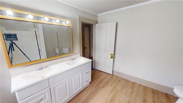 1204 N Franklin St, Danville, IL 61832 - bathroom featuring toilet, wood finished floors, double vanity, and crown molding