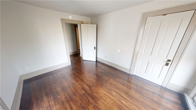 1204 N Franklin St, Danville, IL 61832 - unfurnished bedroom featuring dark wood finished floors and baseboards