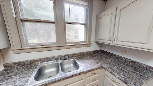 1204 N Franklin St, Danville, IL 61832 - kitchen featuring a sink, dark countertops, and white cabinets