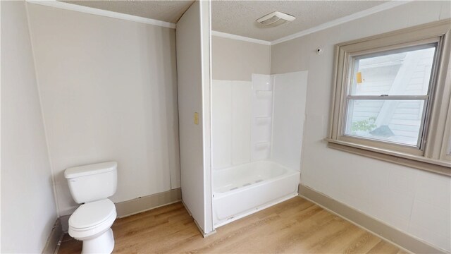 1204 N Franklin St, Danville, IL 61832 - full bathroom with wood finished floors, healthy amount of natural light, toilet, ornamental molding, and bathtub / shower combination