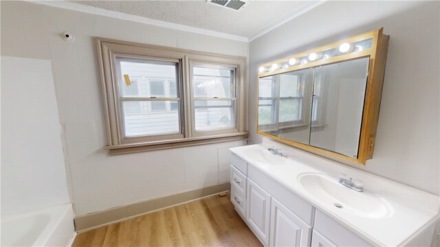1204 N Franklin St, Danville, IL 61832 - bathroom with crown molding, wood finished floors, double vanity, a tub, and baseboards