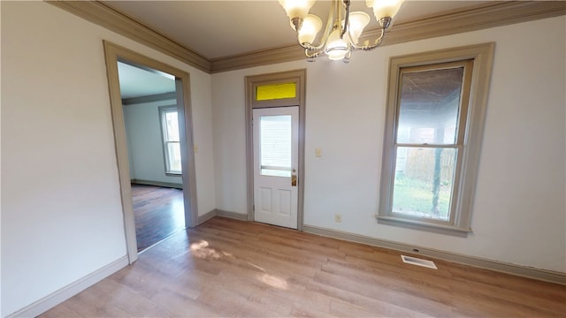 1204 N Franklin St, Danville, IL 61832 - entryway with crown molding, a chandelier, healthy amount of natural light, light wood-type flooring, and baseboards