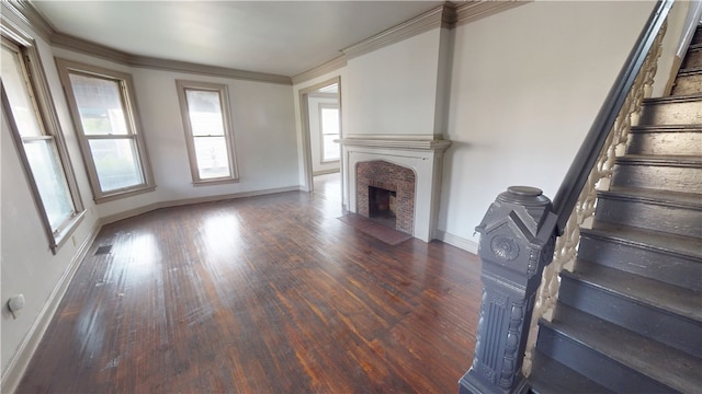1204 N Franklin St, Danville, IL 61832 - unfurnished living room featuring a fireplace, stairs, baseboards, wood finished floors, and crown molding