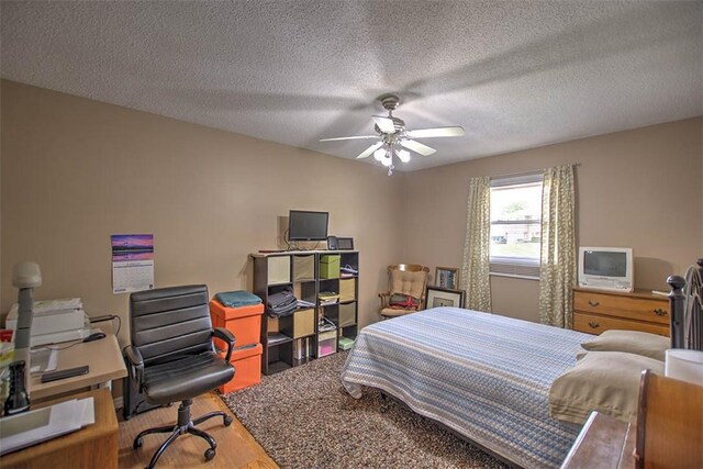 1065 S Wildwood Dr, Mt Zion, IL 62549 - bedroom featuring an office area, wood finished floors, ceiling fan, and a textured ceiling