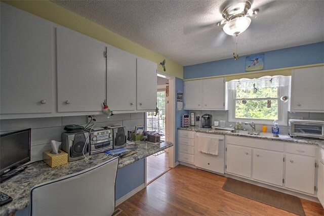1065 S Wildwood Dr, Mt Zion, IL 62549 - kitchen featuring dishwasher, a textured ceiling, light wood-style flooring, a ceiling fan, and white cabinets
