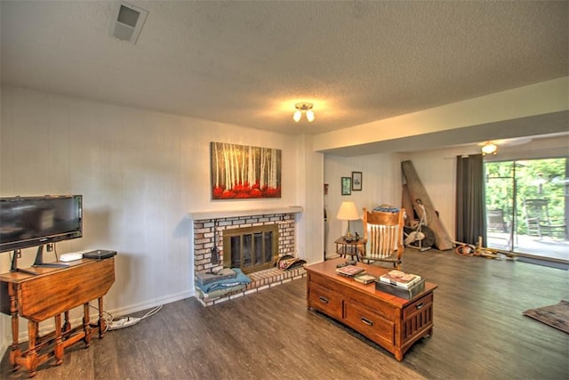 1065 S Wildwood Dr, Mt Zion, IL 62549 - living area with wood finished floors, a textured ceiling, and a fireplace