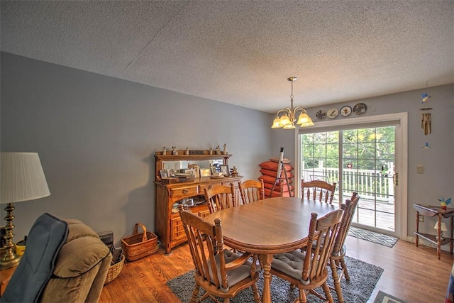 1065 S Wildwood Dr, Mt Zion, IL 62549 - dining area with a textured ceiling, a chandelier, and light wood-style floors
