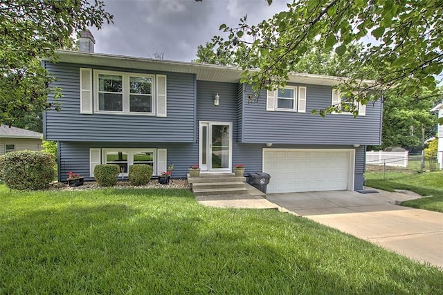 1065 S Wildwood Dr, Mt Zion, IL 62549 - split foyer home featuring a garage, a chimney, and concrete driveway